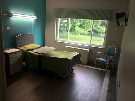 A bright, clean resident room with a bed and window