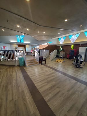 Interior view of a common area with seating and exercise equipment