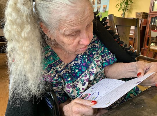 Resident reading a letter in a communal space