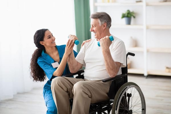 A caregiver assisting a resident with exercise in a facility