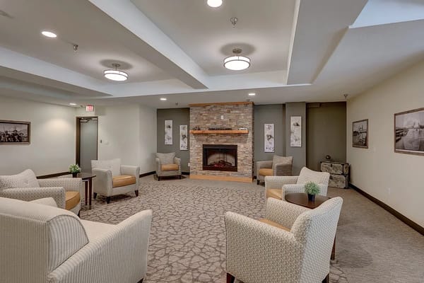 Common area with seating and fireplace in a nursing home