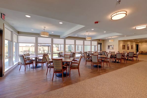 Spacious common area with tables and chairs