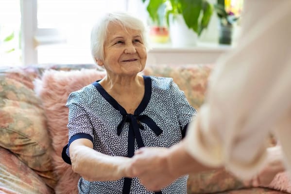 An elderly woman enjoying a moment with a caregiver