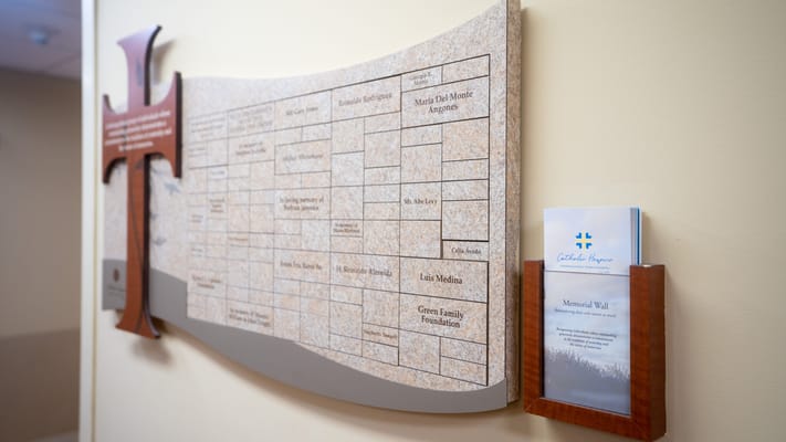Memorial wall with plaques and informational brochure
