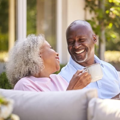 Couple enjoying coffee in a sunny outdoor space