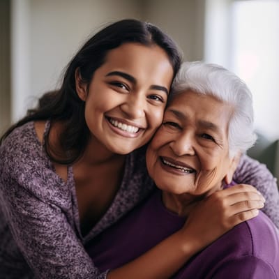 Smiling resident and staff member in a cozy setting