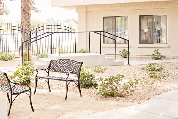 Outdoor seating area with benches and landscaping