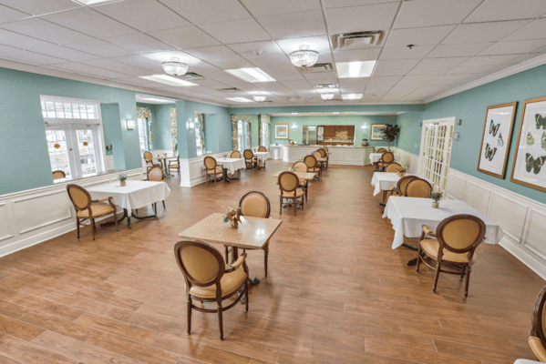 Bright dining room with tables and chairs set.
