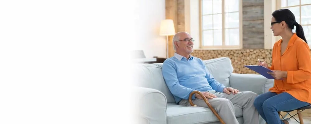 A staff member interacting with a resident in the lounge