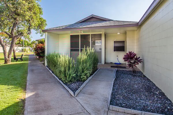 Entrance of a senior living facility with landscaping