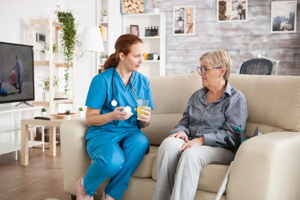 A caregiver conversing with a senior resident in a cozy living room