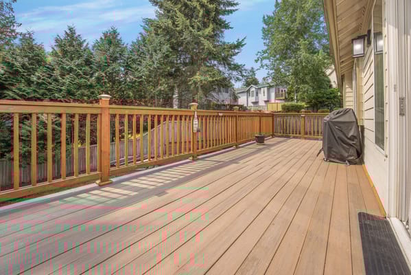 Spacious outdoor deck with wooden railing