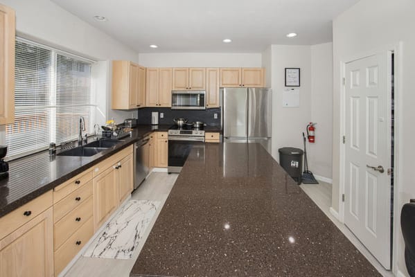 Spacious kitchen with granite countertops and modern appliances