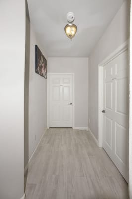 Bright hallway with doors leading to private rooms