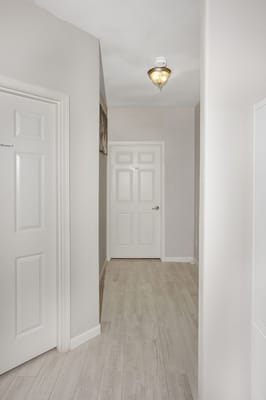 A hallway with doors leading to resident rooms