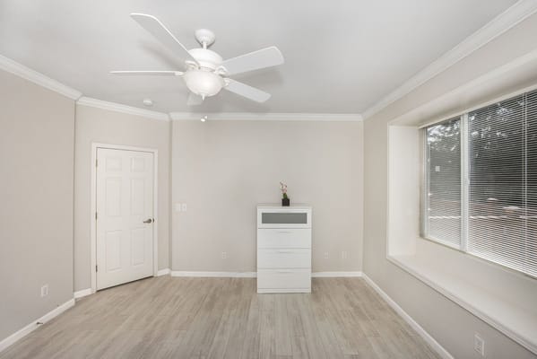 Bright private room with a window and furniture