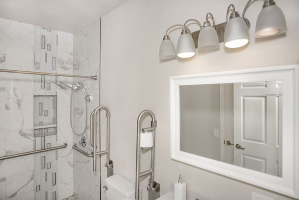 Accessible bathroom with grab bars and lighting