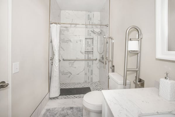 Modern bathroom featuring grab bars and accessible fixtures