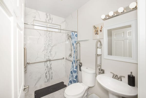 Accessible bathroom with grab bars and modern fixtures