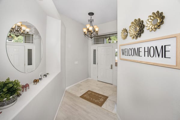 Welcoming interior entryway with decor and a sign