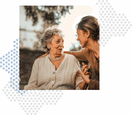 Smiling elderly woman enjoying time with caregiver outdoors