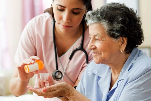 Nurse assisting a resident with medication