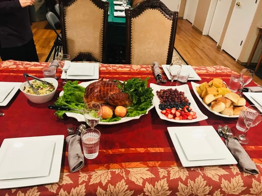 Dining room table set with a feast, ready for residents