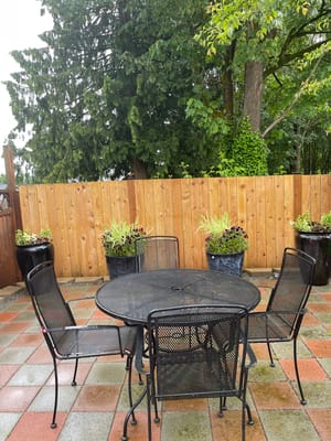 Outdoor seating area with a round table and chairs