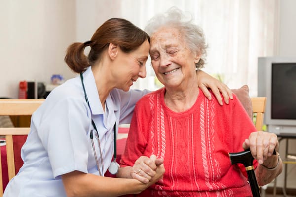 A caregiver and resident sharing a joyful moment