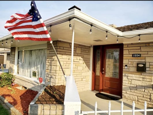 Exterior view of a facility with an American flag