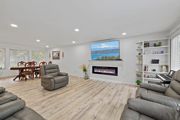 Bright interior common area with seating and a large TV