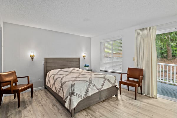 Private resident room with a bed and chairs