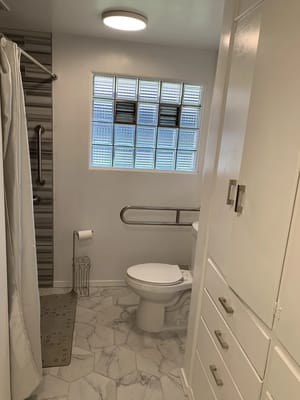 Bright bathroom with modern fixtures and glass block window