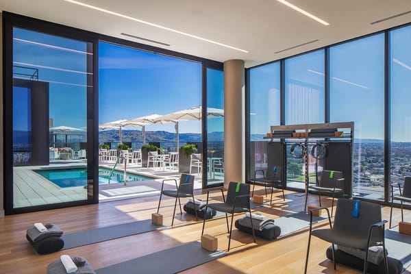 Bright fitness area with mats and outdoor views