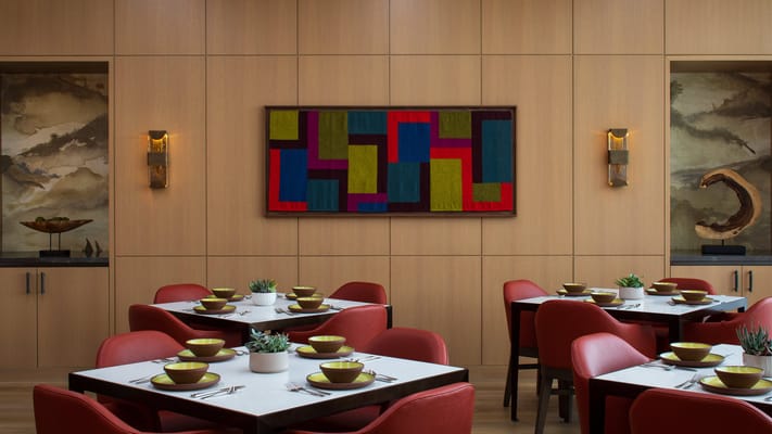 Dining area with modern decor and vibrant artwork