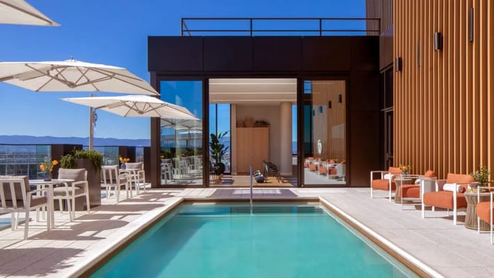 Outdoor pool area with seating and umbrellas