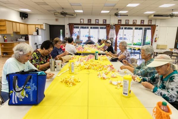 Residents crafting flowers in a common area