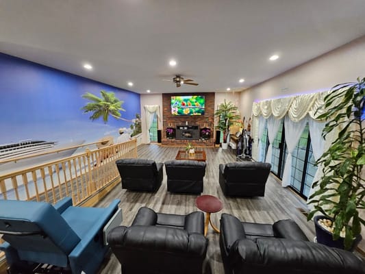 Interior view of a common area with seating and a large TV