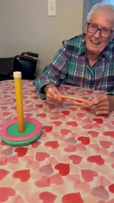 Resident enjoying a game at a table