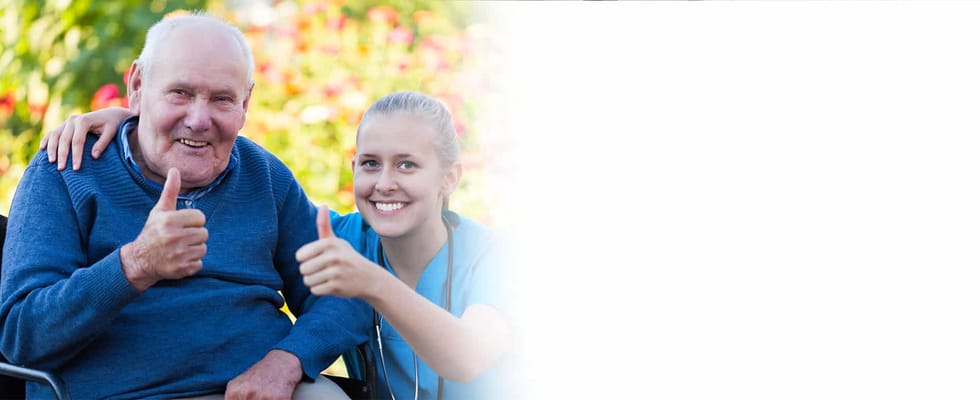 Happy resident and staff member giving thumbs up outdoors