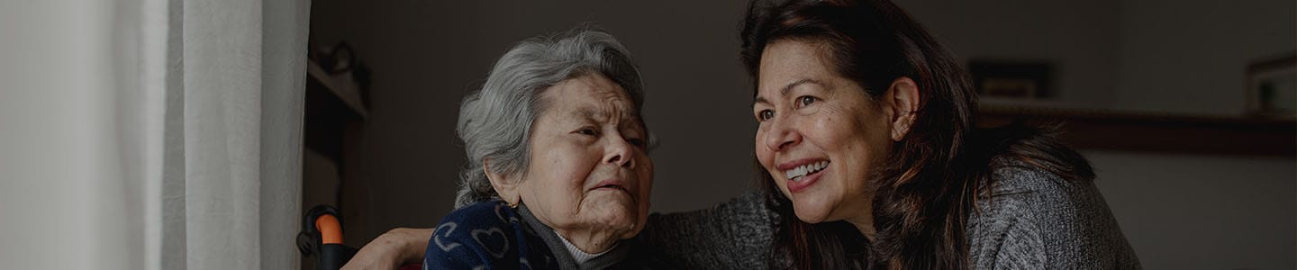 Caregiver smiling with a resident in a cozy room
