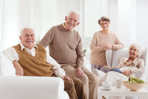 Group of smiling seniors in a bright common area