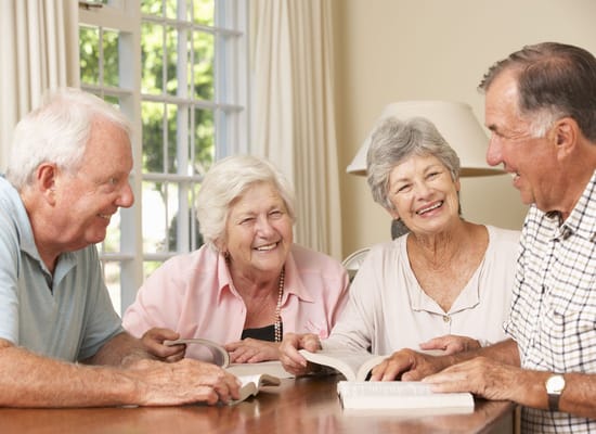 Seniors engaging and smiling around a table