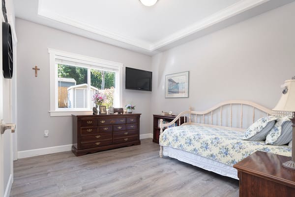 Cozy bedroom with floral bedding and dresser