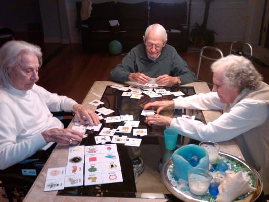 Residents participating in a card game at a table