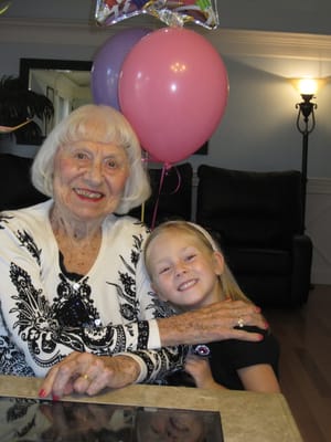A senior resident and a young girl celebrating together