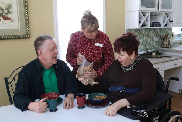 Residents and staff enjoying a meal together