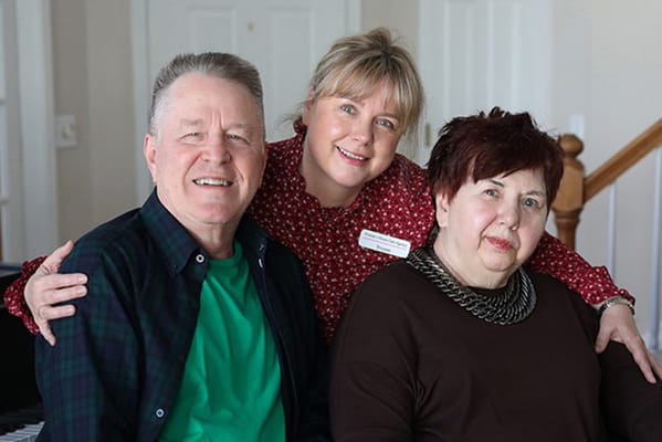 Residents and staff posing together in a common area