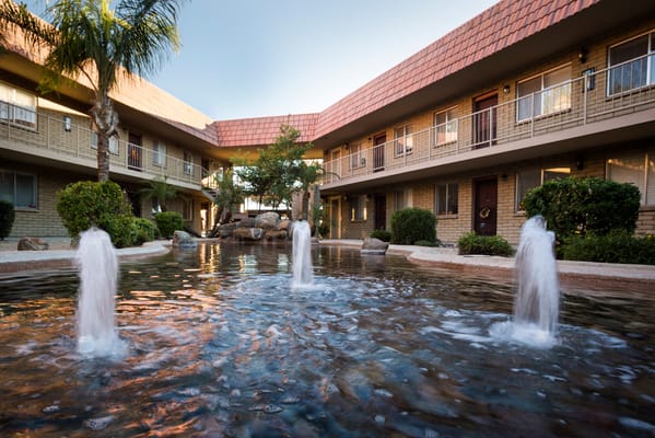 Outdoor courtyard with water features and landscaping