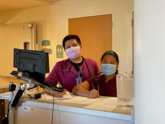 Two staff members at the nursing station